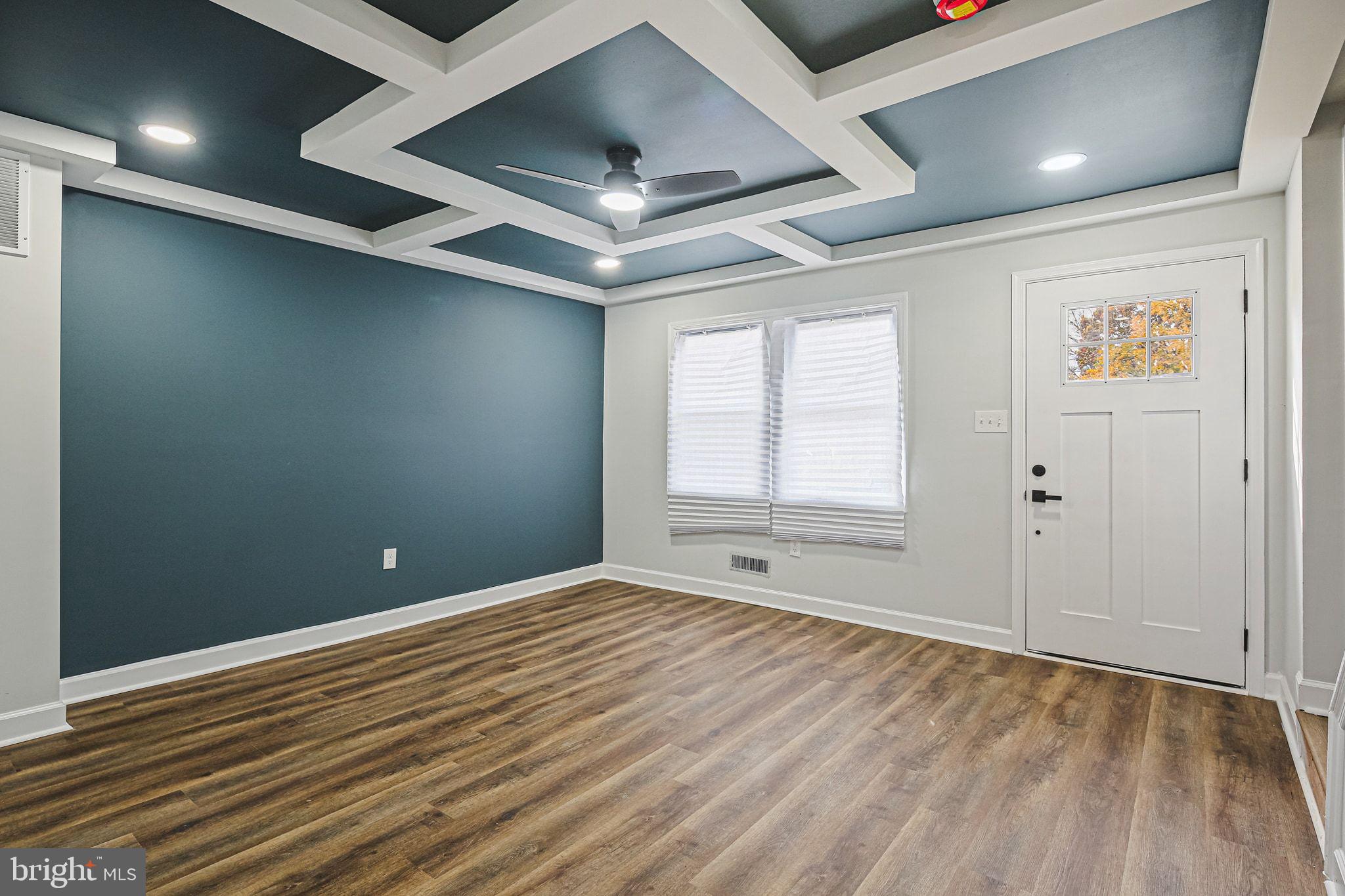 4702 Vancouver Road Baltimore, MD 21229 - Photo 4 of 33 an empty room with wooden floor and windows