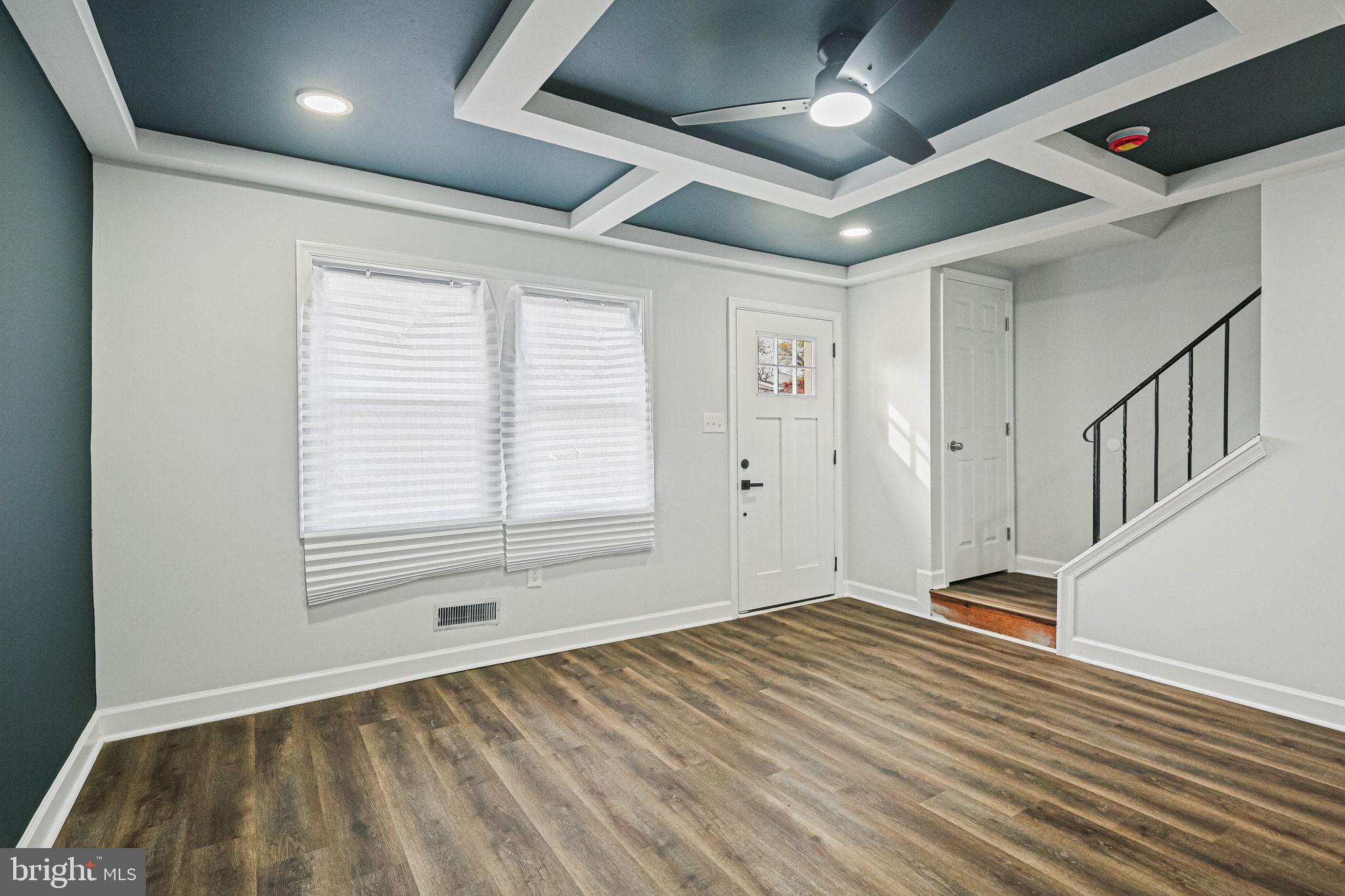 4702 Vancouver Road Baltimore, MD 21229 - Photo 5 of 33 a view of an empty room with wooden floor and a window