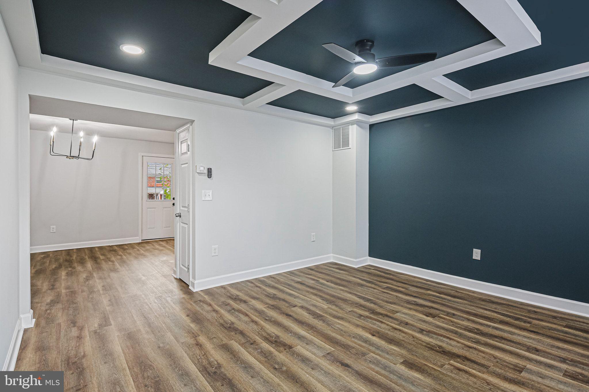 4702 Vancouver Road Baltimore, MD 21229 - Photo 7 of 33 en empty room with wooden floor and windows