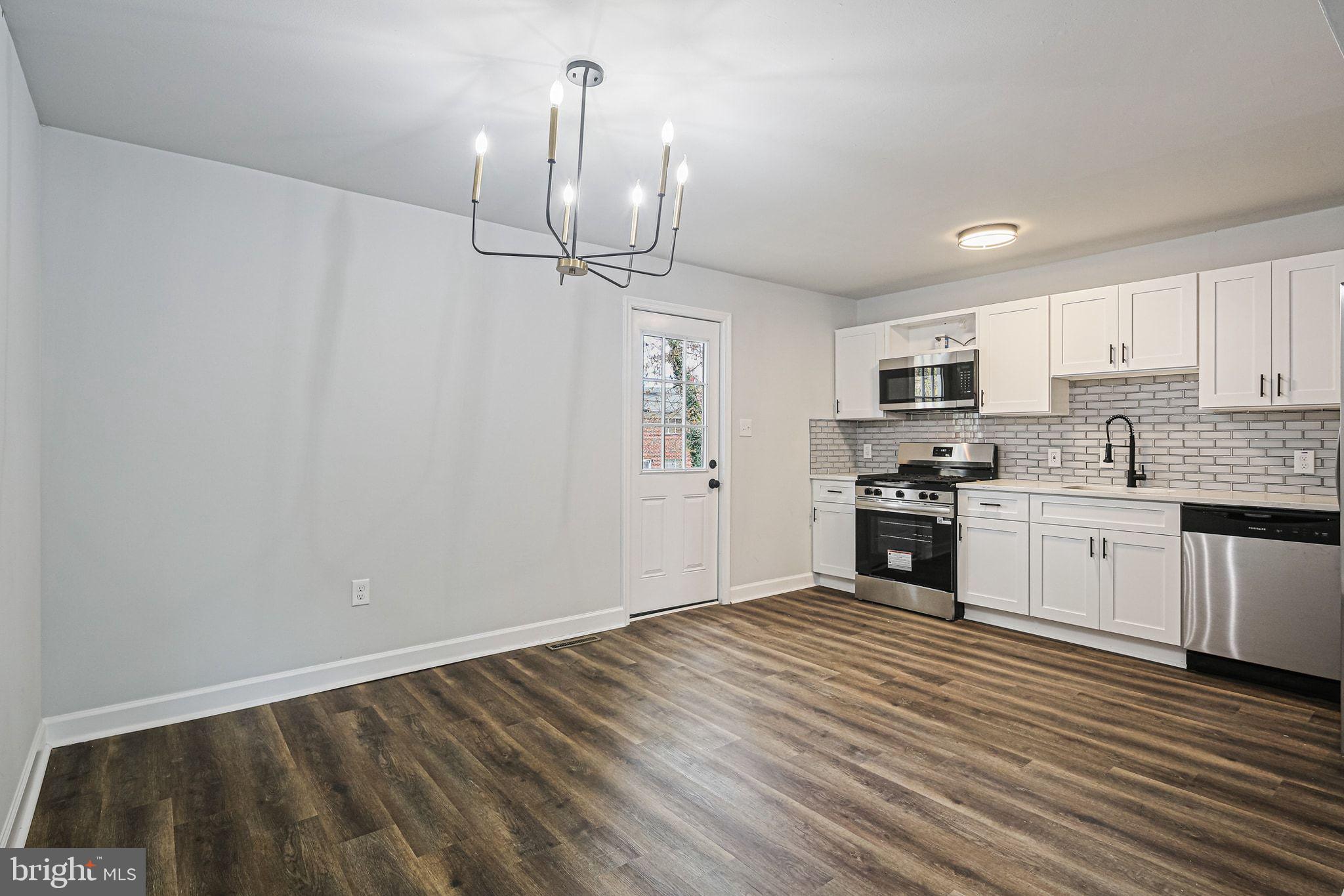 4702 Vancouver Road Baltimore, MD 21229 - Photo 10 of 33 a kitchen with granite countertop a sink cabinets and stainless steel appliances