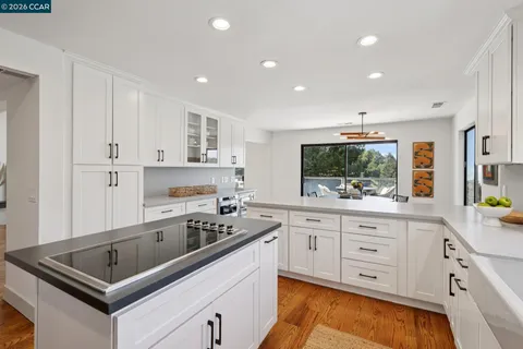 a kitchen that has a sink and a stove in it