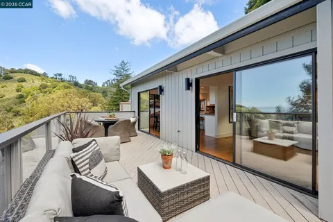 a view of balcony with furniture and wooden floor