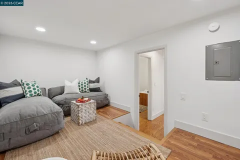 a living room with furniture and wooden floor