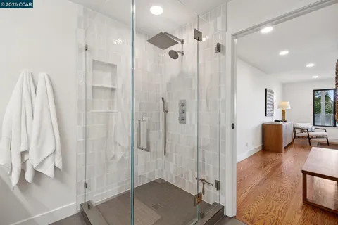 a spacious bathroom with a glass shower door and a sink