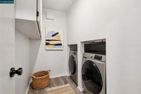 a view of a hallway with washer and dryer