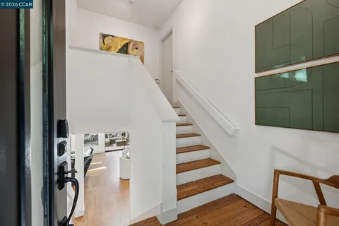 a view of a hallway with wooden floor and entryway