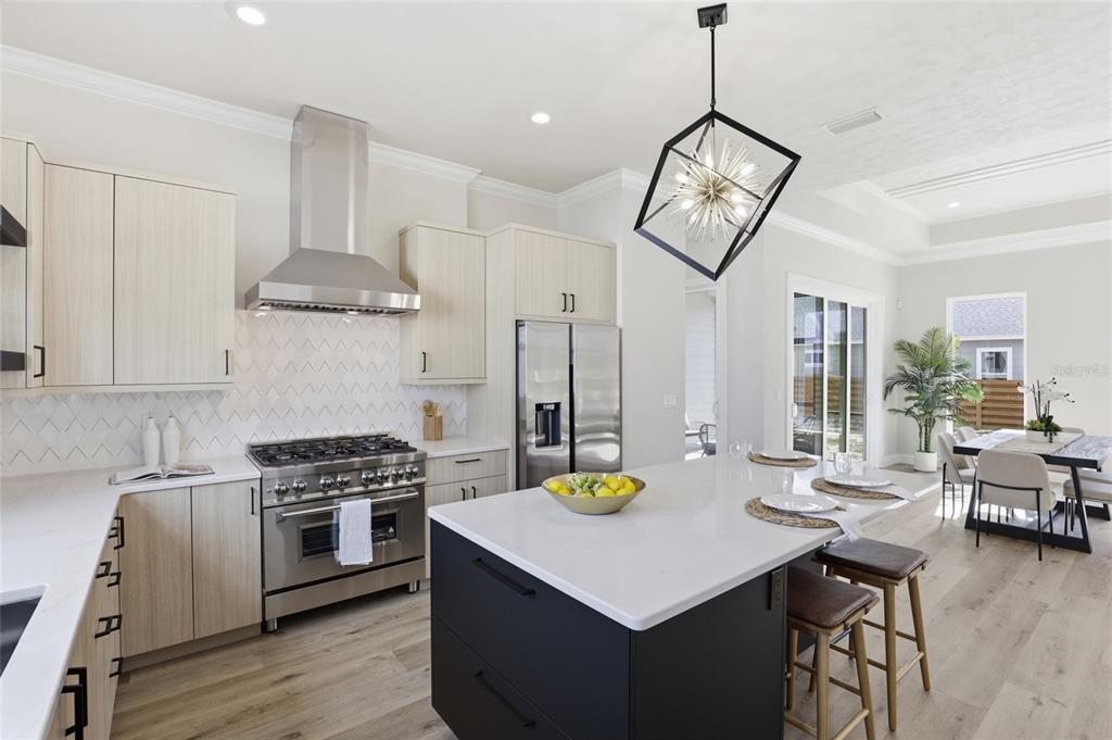 13425 Southwest 9th Road Newberry, FL 32669 - Photo 5 of 46 a view of kitchen island with stainless steel appliances stove a dining table and chairs