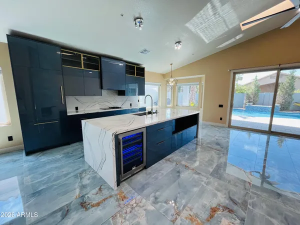 a kitchen with stainless steel appliances granite countertop a stove a sink and a refrigerator