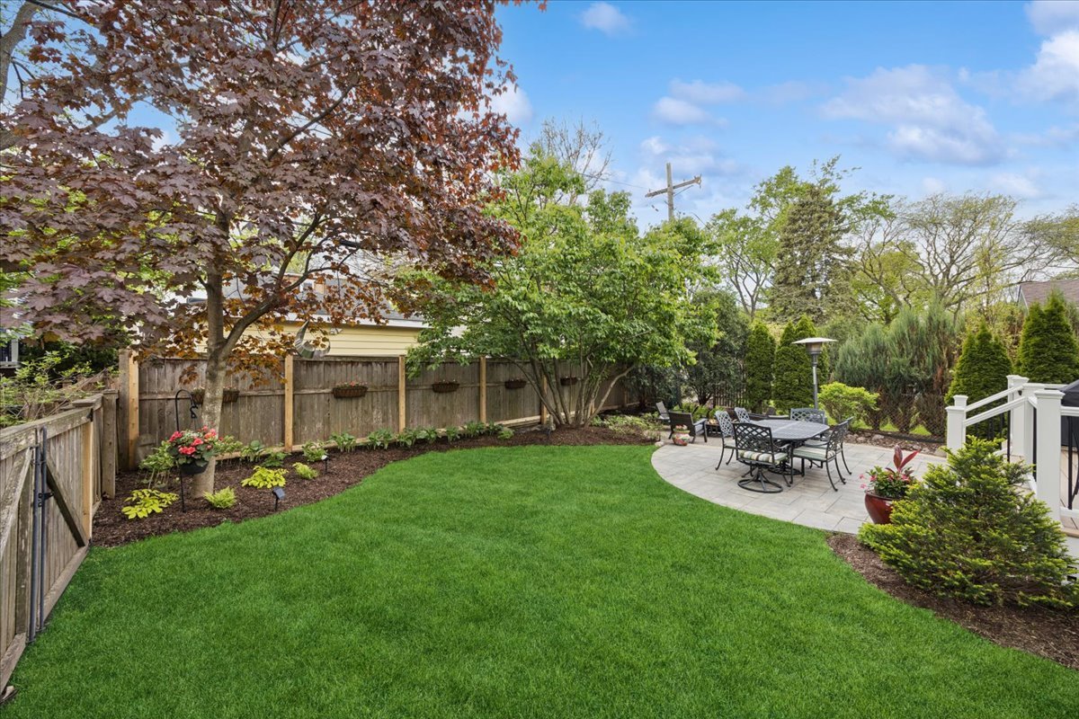 749 Summit Street Downers Grove, IL 60515 - Photo 31 of 32 a view of a patio with table and chairs and potted plants with large tree