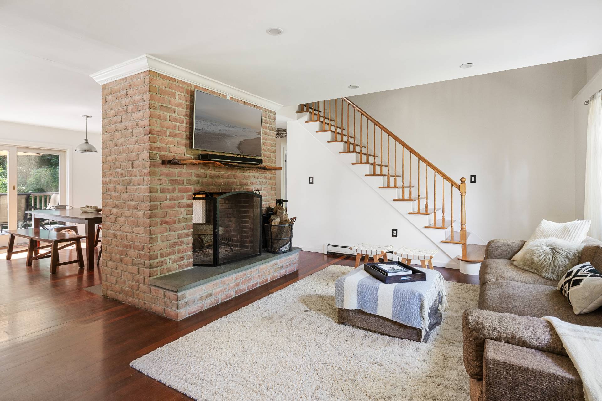 312 Noyack Road Southampton, NY 11968 - Photo 5 of 18 a living room with furniture flat screen tv and a fireplace