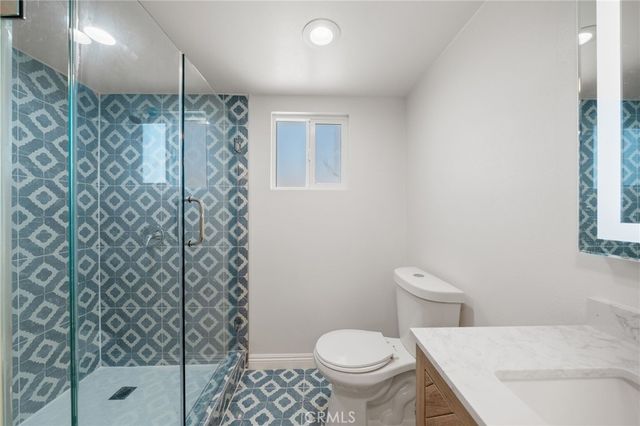 a white toilet sitting next to a shower curtain