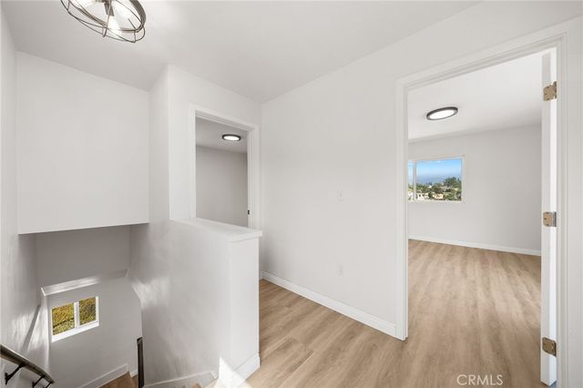 a view of an entryway with wooden floor