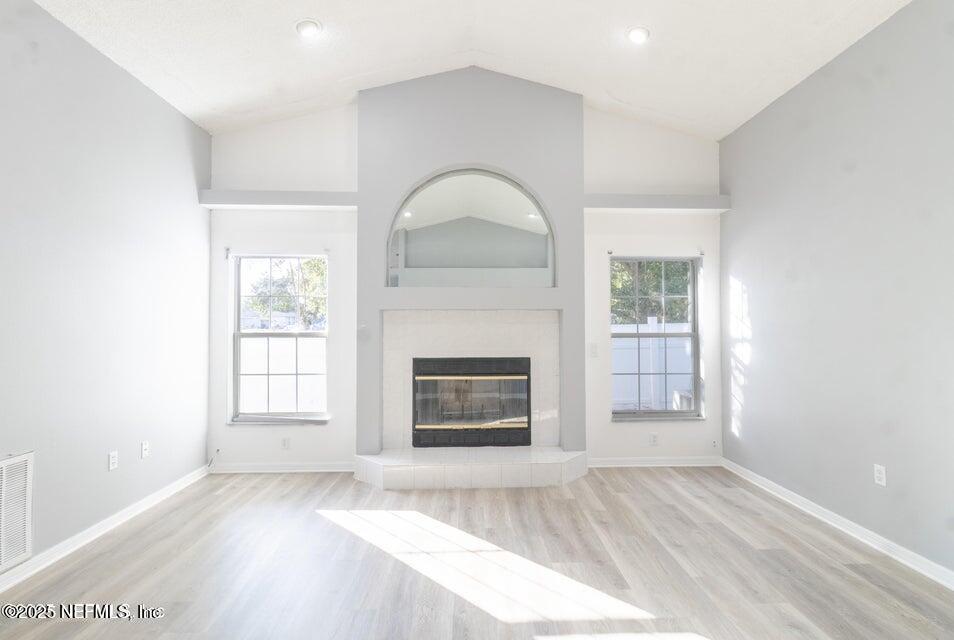 3955 Southwest 139th St Road Ocala, FL 34473 - Photo 14 of 45 an empty room with fireplace and windows