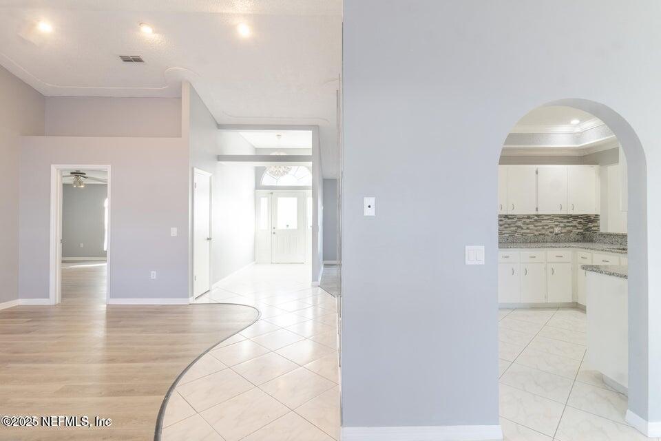 3955 Southwest 139th St Road Ocala, FL 34473 - Photo 16 of 45 a view of a hallway with wooden floor and cabinet