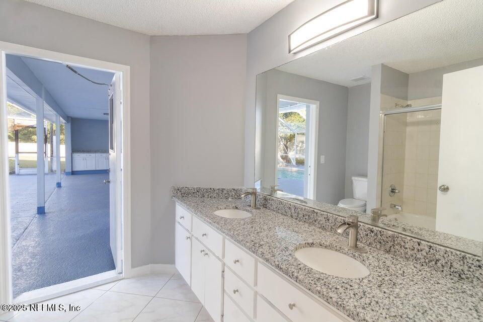 3955 Southwest 139th St Road Ocala, FL 34473 - Photo 22 of 45 a bathroom with a granite countertop sink and a mirror