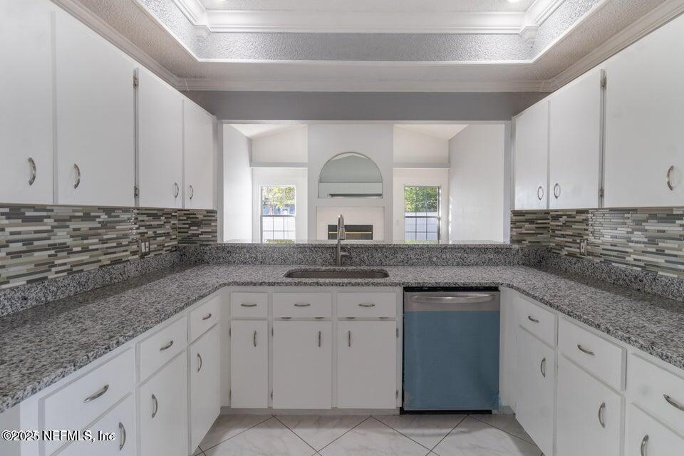 3955 Southwest 139th St Road Ocala, FL 34473 - Photo 27 of 45 a kitchen with granite countertop white cabinets and white appliances
