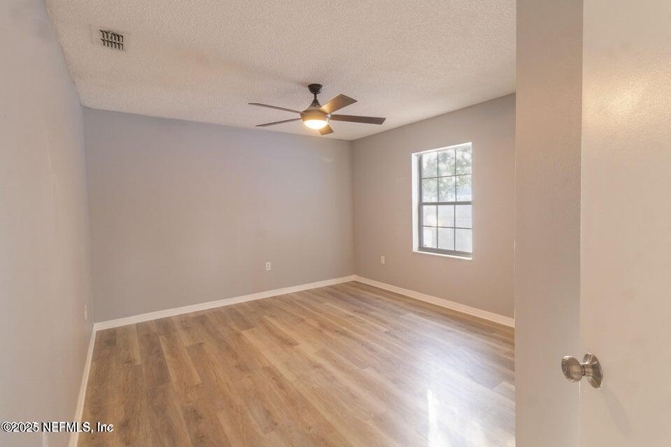 3955 Southwest 139th St Road Ocala, FL 34473 - Photo 35 of 45 wooden floor in an empty room with a window