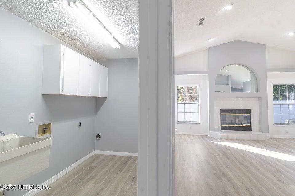 3955 Southwest 139th St Road Ocala, FL 34473 - Photo 38 of 45 a view of a kitchen with a sink a fireplace and wooden floor