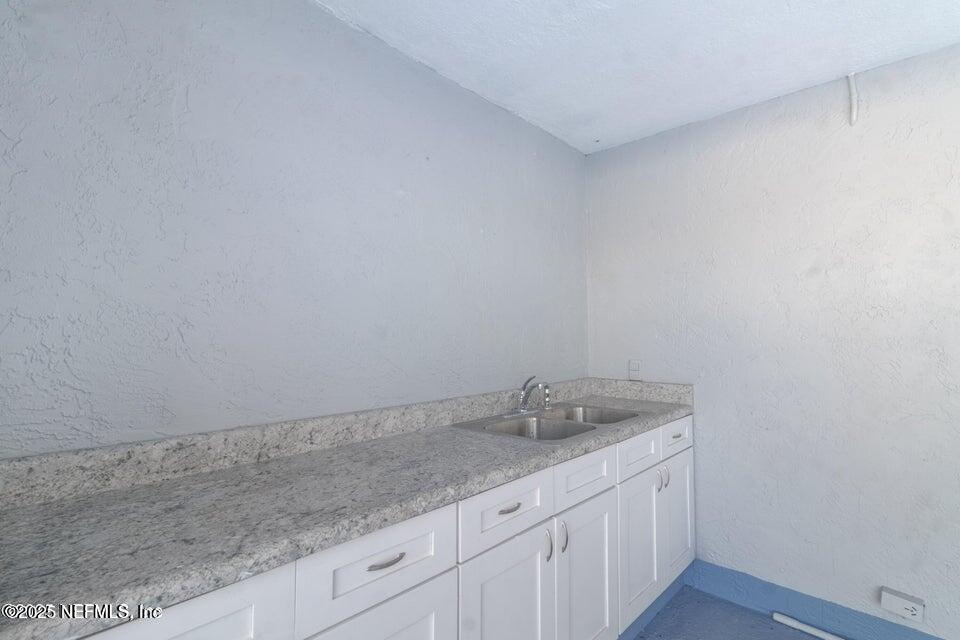3955 Southwest 139th St Road Ocala, FL 34473 - Photo 39 of 45 a bathroom with a granite countertop sink and white cabinets