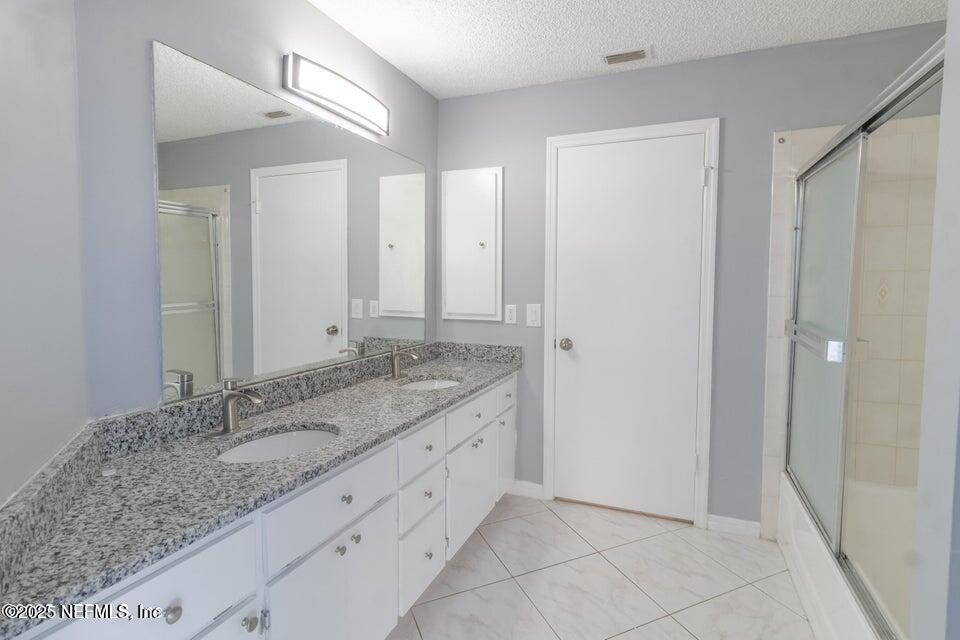3955 Southwest 139th St Road Ocala, FL 34473 - Photo 43 of 45 a bathroom with a granite countertop sink and a mirror