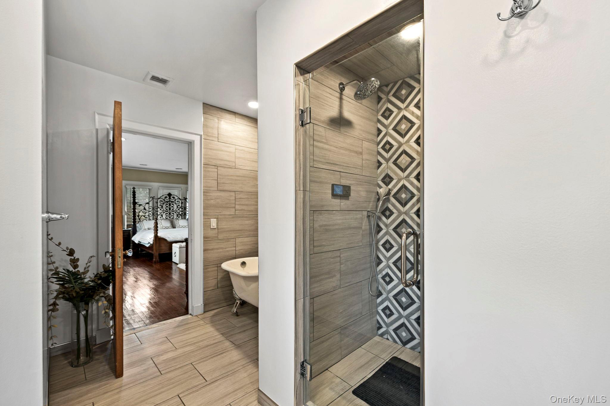 44 Fenimore Road New Rochelle, NY 10804 - Photo 20 of 46 a view of a hallway with wooden floor and a bathroom