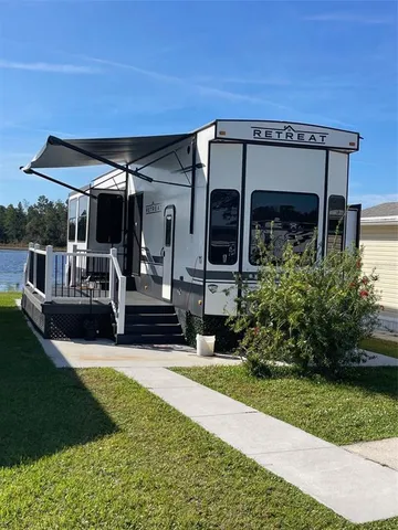 a view of a house with backyard and porch