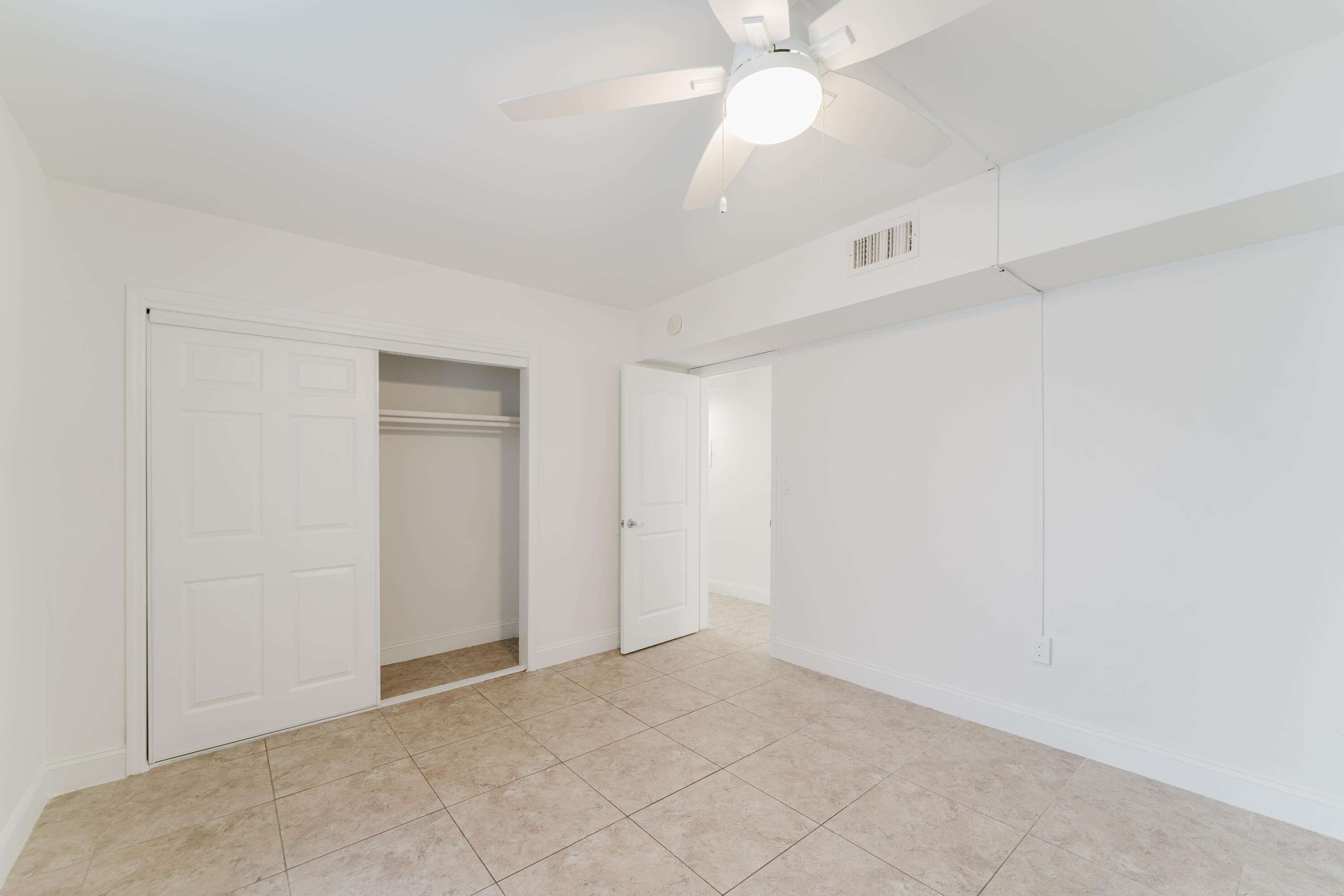 601 Southwest 2nd Avenue, Unit 5 Boca Raton, FL 33432 - Photo 19 of 26 an empty room with a fan and a fan