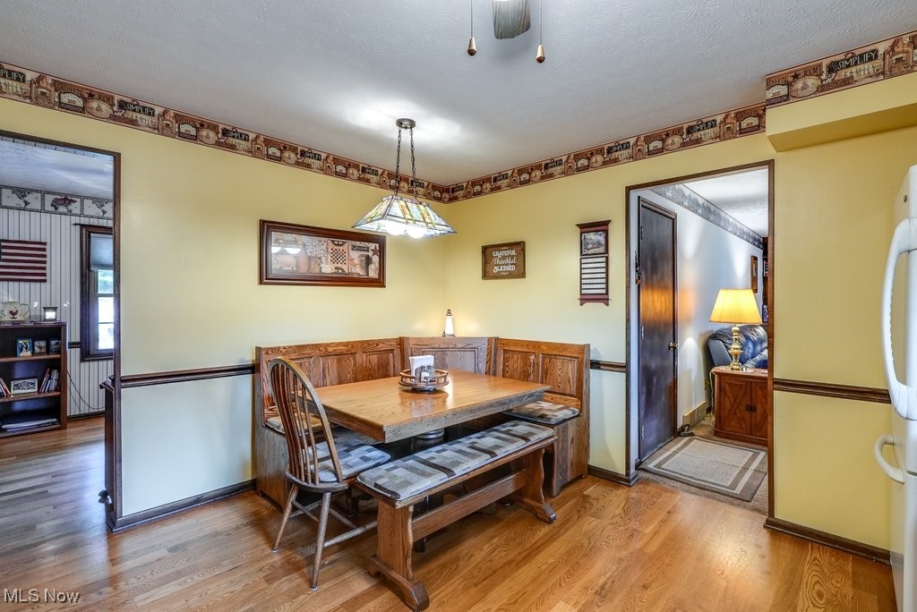2573 Killian Road Uniontown, OH 44685 - Photo 13 of 40 Dining area featuring hardwood / wood-style floors and a textured ceiling