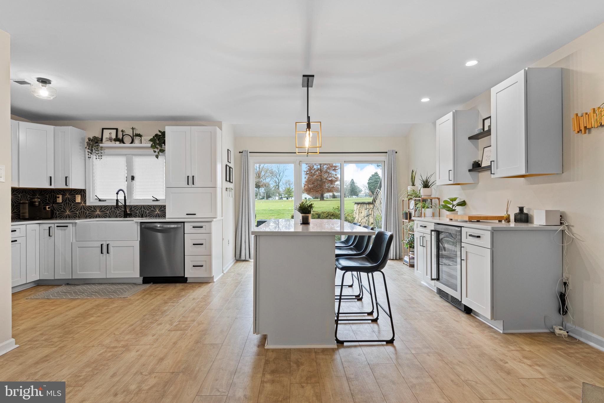 649 Niblick Lane, Unit 20 Wallingford, PA 19086 - Photo 15 of 35 a kitchen with kitchen island granite countertop a sink cabinets and wooden floor