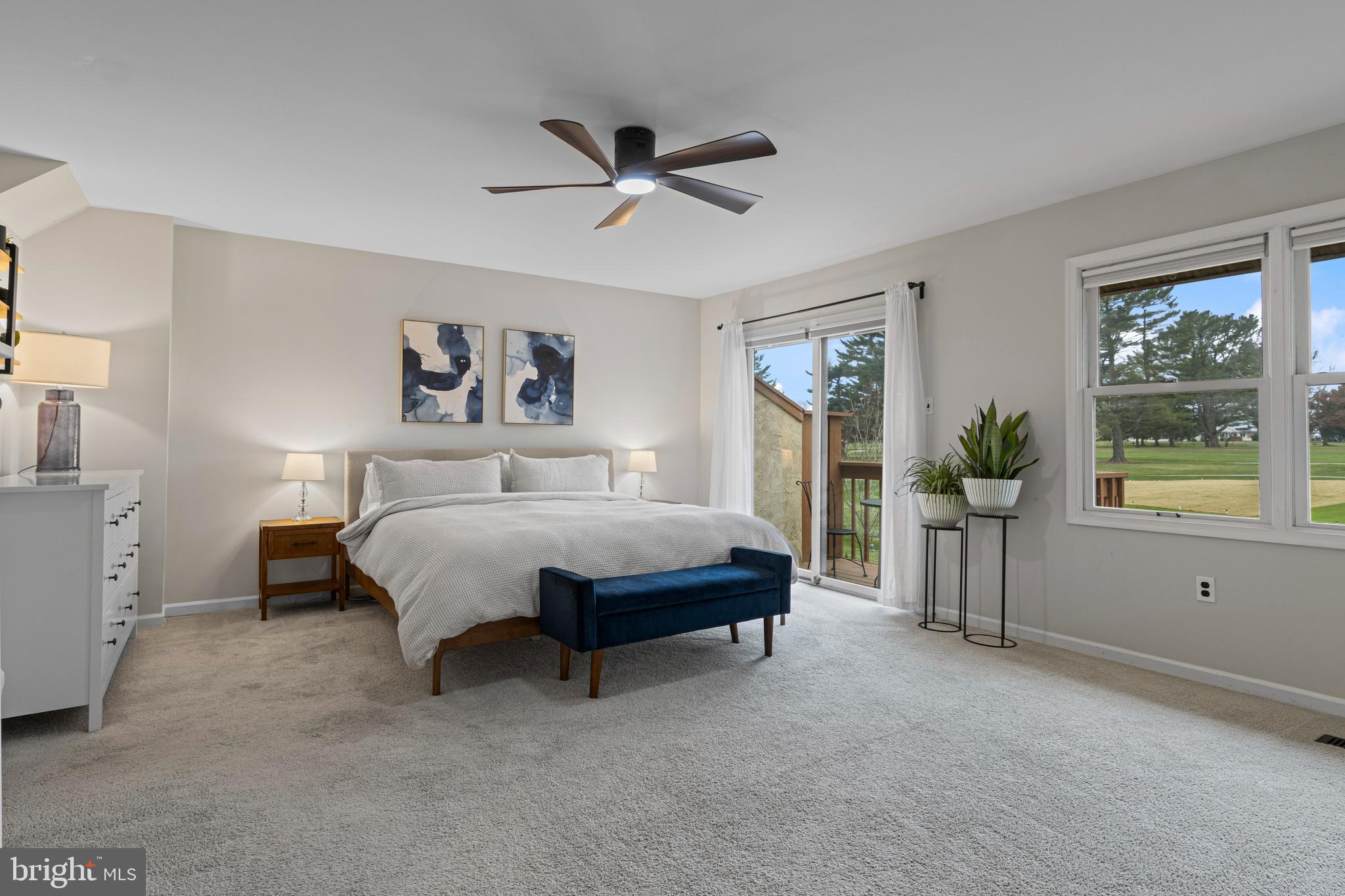 649 Niblick Lane, Unit 20 Wallingford, PA 19086 - Photo 26 of 35 a spacious bedroom with a bed and a chandelier