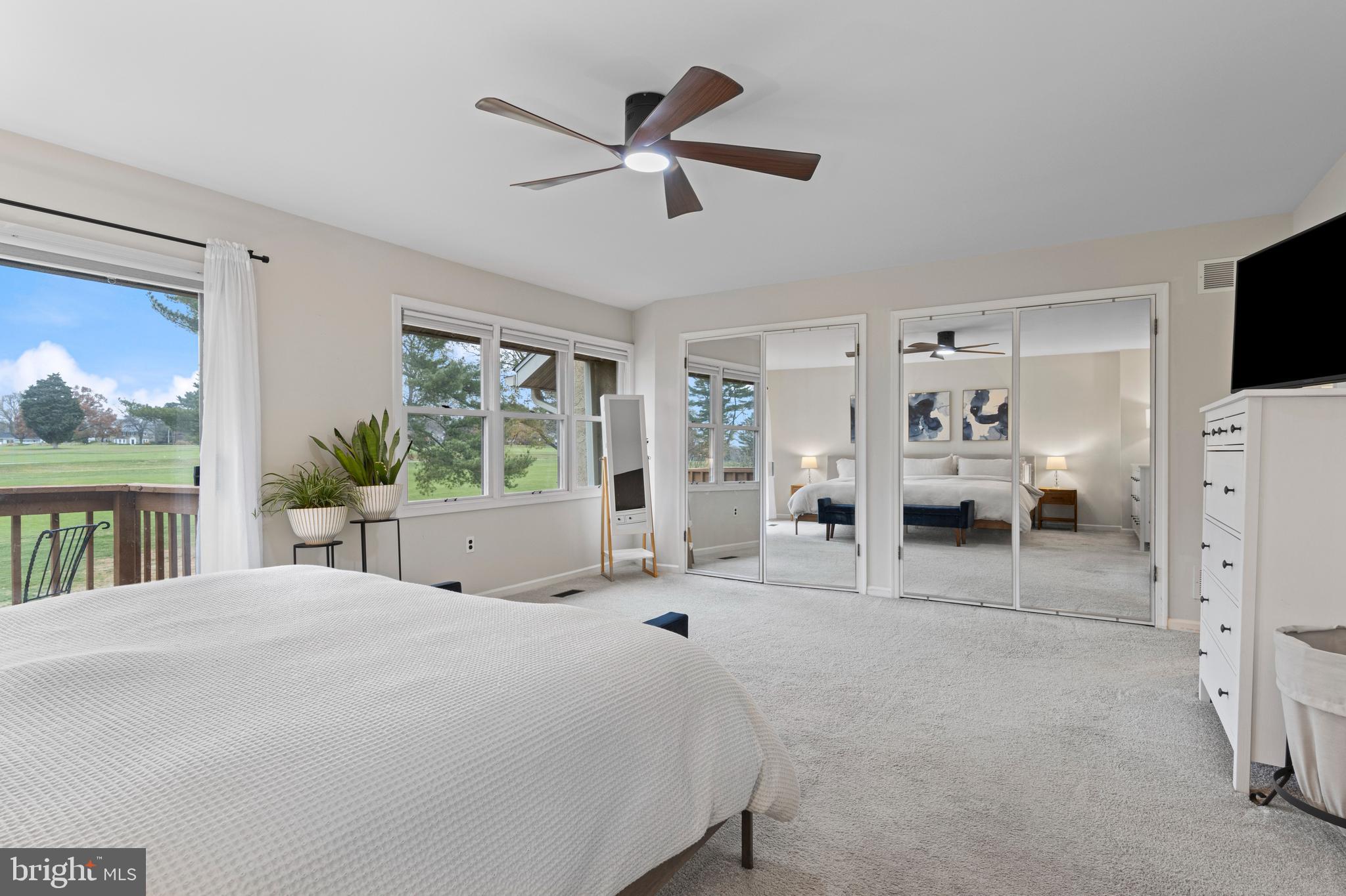 649 Niblick Lane, Unit 20 Wallingford, PA 19086 - Photo 27 of 35 a bedroom with a bed a large window and a flat screen tv