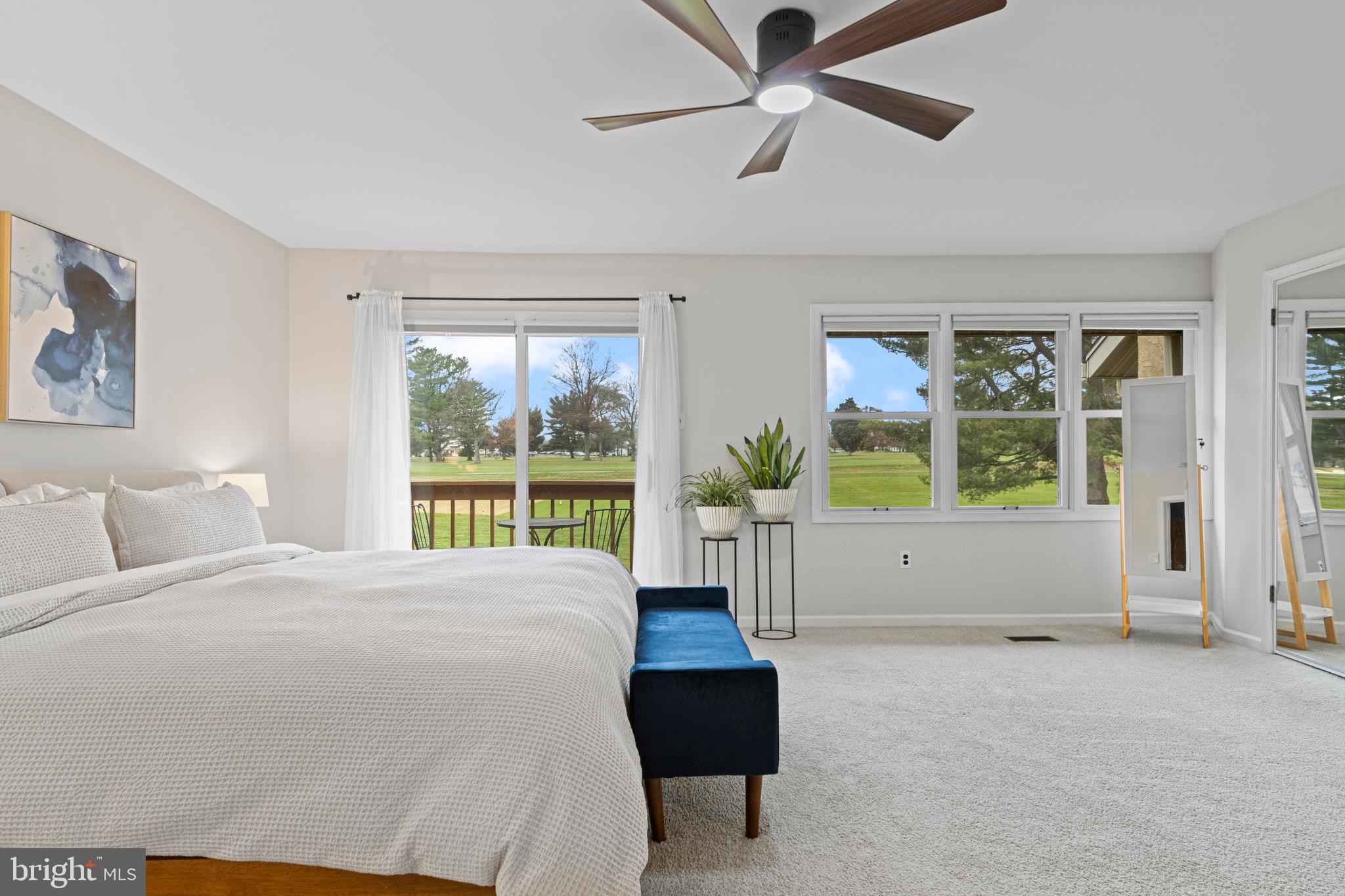 649 Niblick Lane, Unit 20 Wallingford, PA 19086 - Photo 28 of 35 a spacious bedroom with a large bed and a window