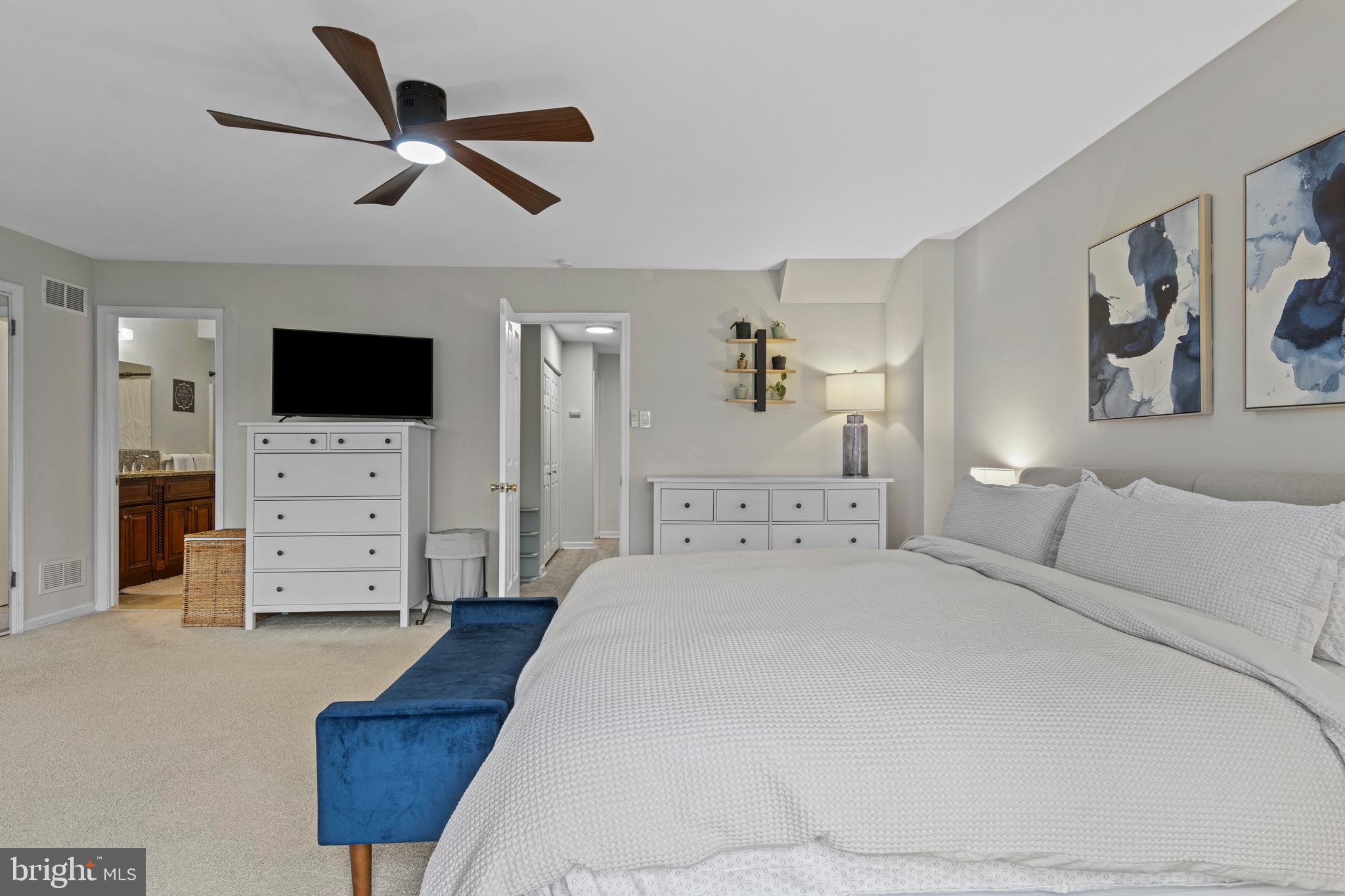 649 Niblick Lane, Unit 20 Wallingford, PA 19086 - Photo 30 of 35 a spacious bedroom with a bed and a flat screen tv