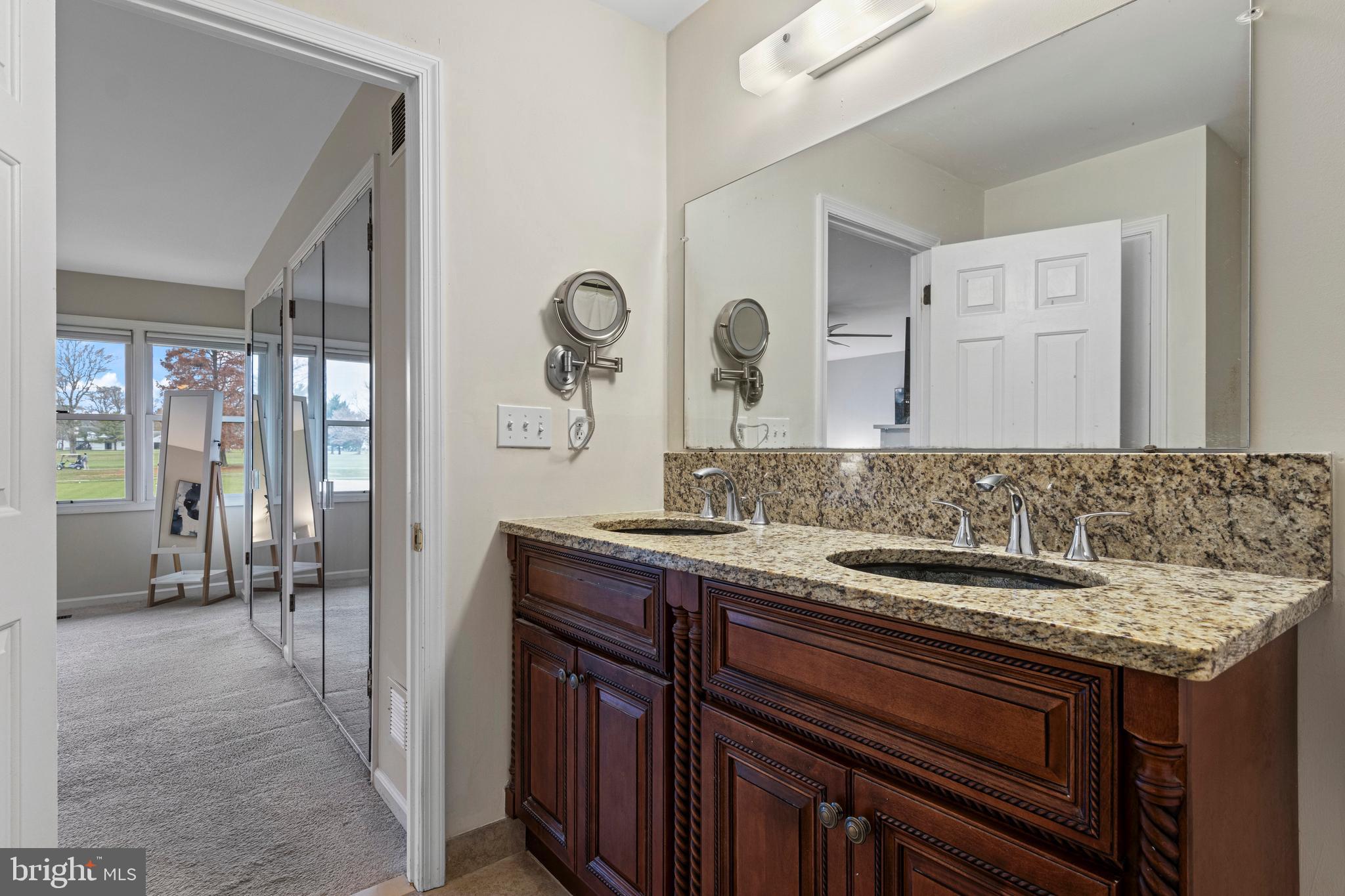 649 Niblick Lane, Unit 20 Wallingford, PA 19086 - Photo 32 of 35 a bathroom with a sink and a mirror