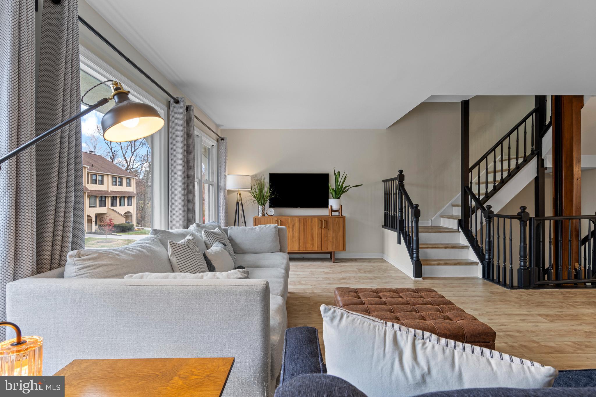 649 Niblick Lane, Unit 20 Wallingford, PA 19086 - Photo 9 of 35 a living room with furniture and a flat screen tv