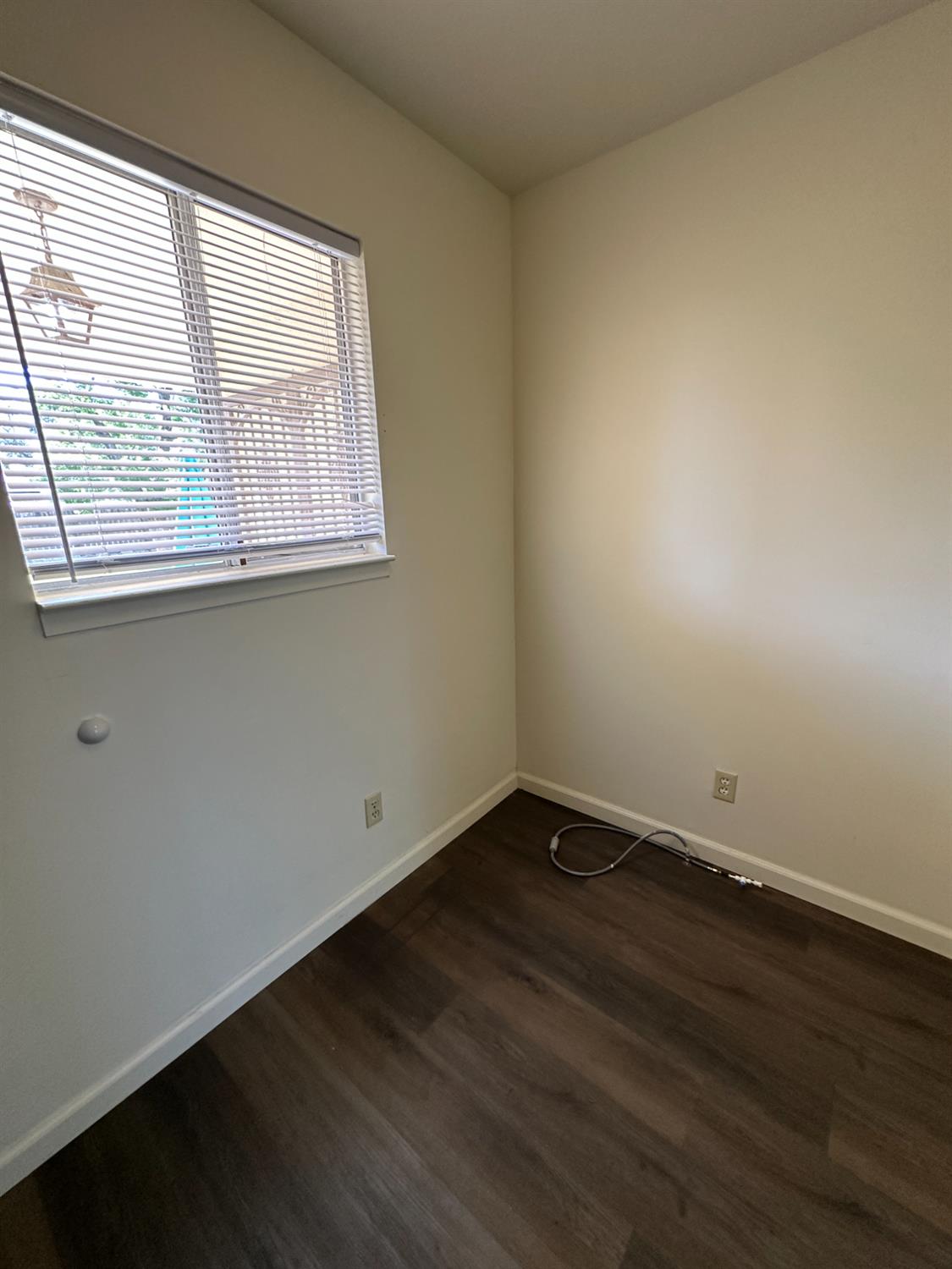 91 O Street Sanger, CA 93657 - Photo 11 of 21 an empty room with wooden floor and windows