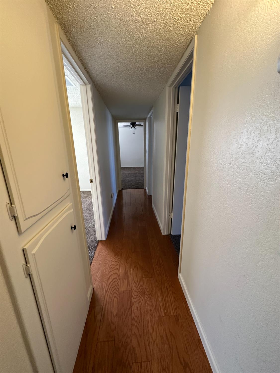 91 O Street Sanger, CA 93657 - Photo 12 of 21 a view of a hallway with wooden floor and staircase