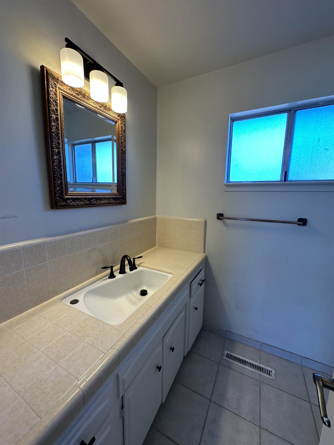 91 O Street Sanger, CA 93657 - Photo 18 of 21 a bathroom with a sink and a mirror