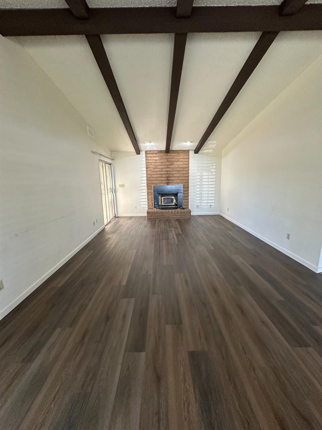 91 O Street Sanger, CA 93657 - Photo 6 of 21 a view of empty room with wooden floor