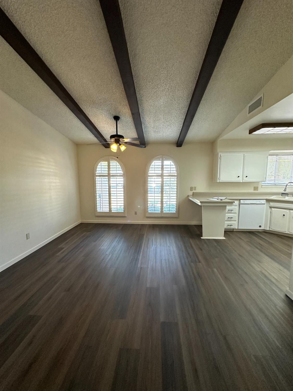 91 O Street Sanger, CA 93657 - Photo 7 of 21 an empty room with wooden floor and windows