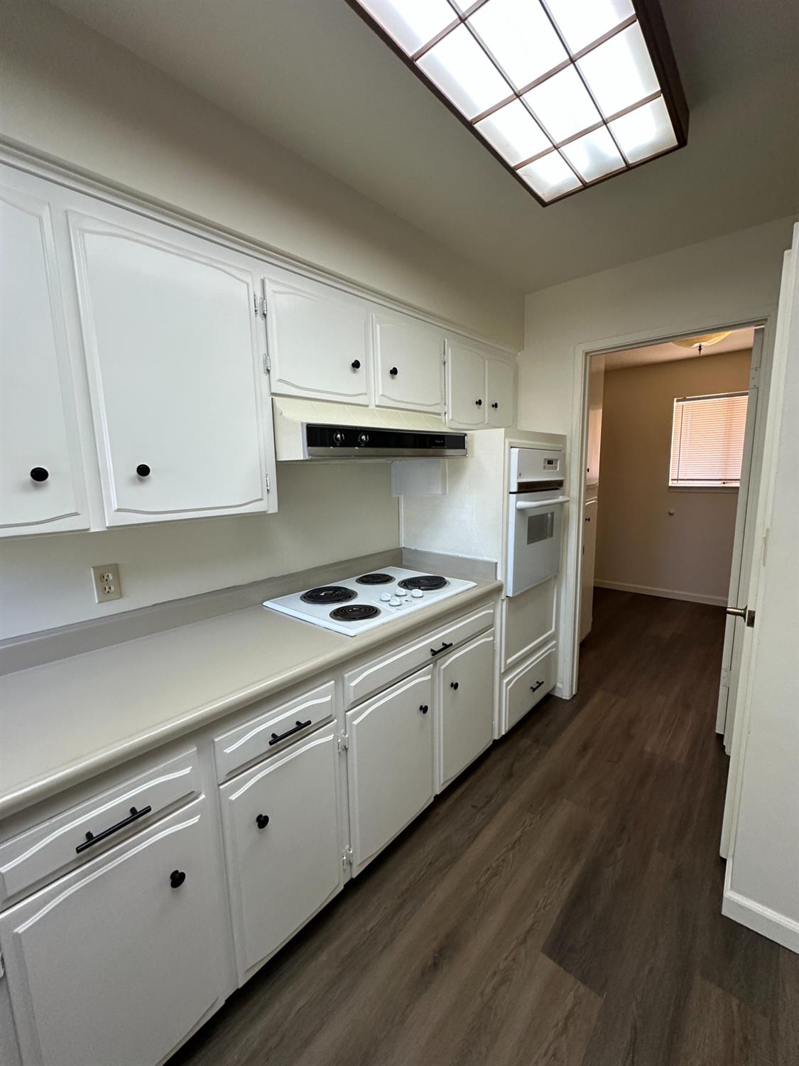 91 O Street Sanger, CA 93657 - Photo 9 of 21 a kitchen with cabinets and wooden floor