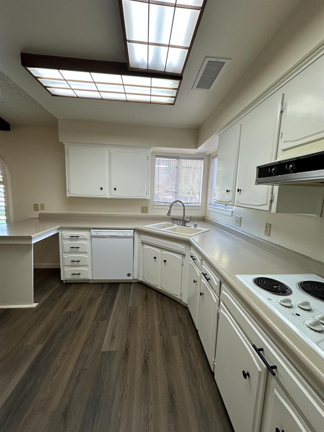 91 O Street Sanger, CA 93657 - Photo 10 of 21 a kitchen with cabinets wooden floor and a sink