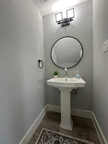 a bathroom with a sink toilet and mirror