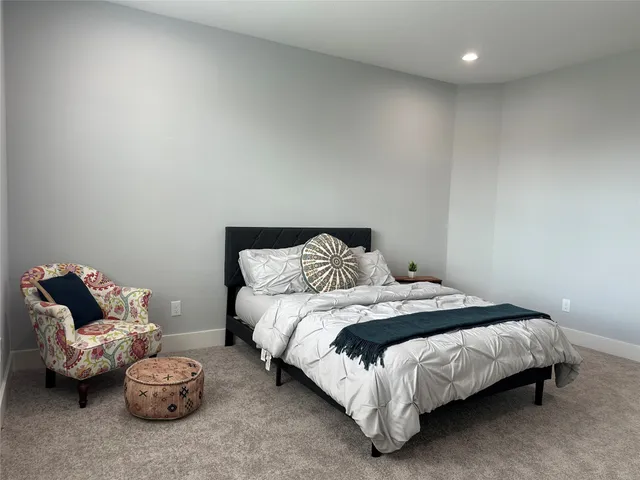 a bedroom with a bed and a couch