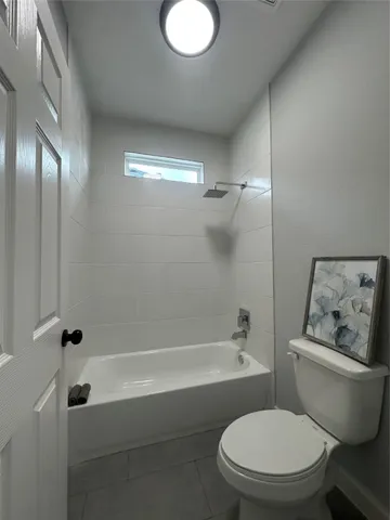 a bathroom with a toilet and a bathtub
