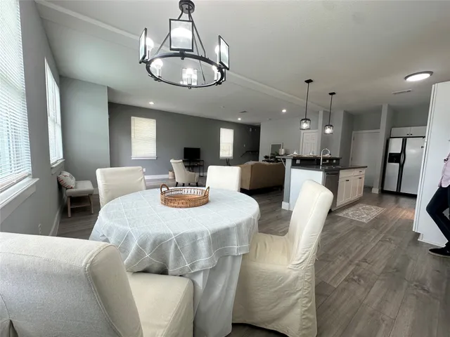 a large white kitchen with a dining table and chairs