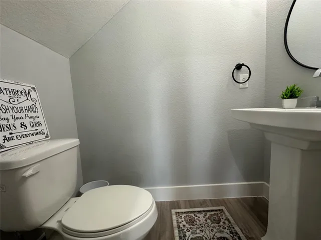 a bathroom with a toilet and a sink