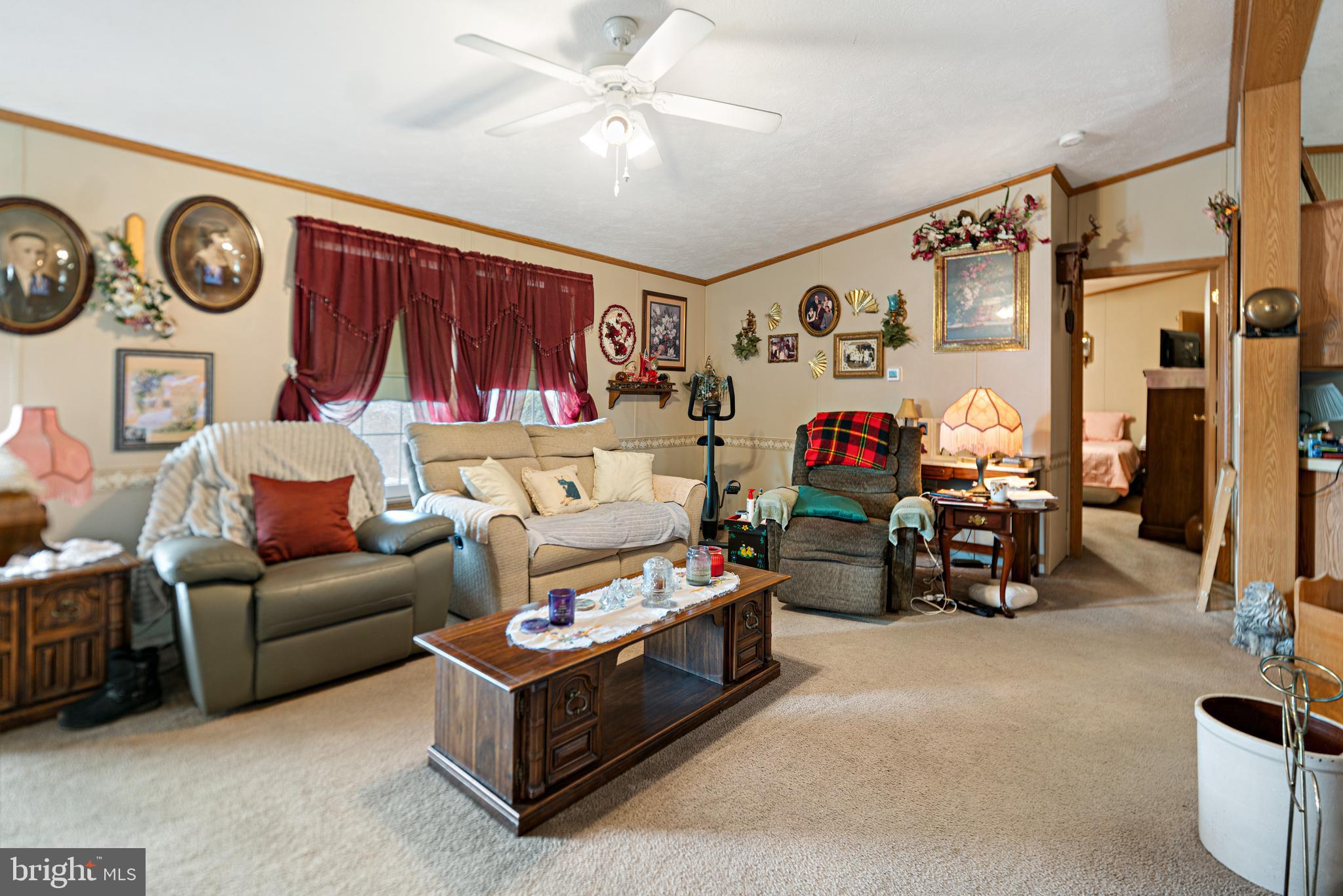 701 Cassel Road, Unit 107 Manchester, PA 17345 - Photo 3 of 21 a living room with furniture a clock and a flat screen tv
