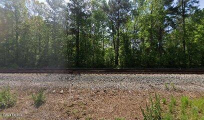 a view of wooden fence and trees