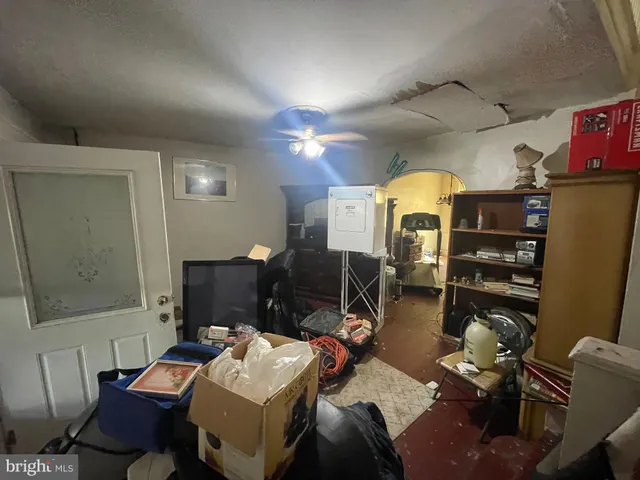 a living room with furniture a flat screen tv and gym equipment